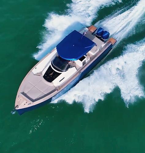 Tesoro T38 Outboard 2022 Tesoro T38 Outboard cruising on turquoise waters, aerial view.