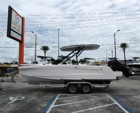Axopar 22 T-Top 2022 Axopar 22 T-Top boat on trailer in parking lot, cloudy sky background.
