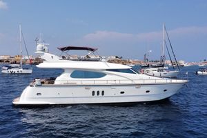 Elegance 64 Luxury Elegance 64 yacht from 2005 cruising in a scenic harbor setting.