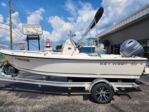 Key West 1720 Center Console 2024 Key West 1720 CC boat on trailer, displayed outdoors under a blue sky.