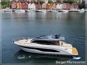 Princess V55 Luxury Princess V55 yacht cruising near colorful Bergen waterfront, 2021 model.