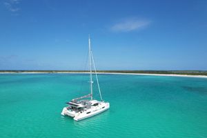 Fountaine Pajot Catamaran Elba 45 2021 Fountaine Pajot Catamaran Elba 45 sailing in turquoise waters under clear blue sky.