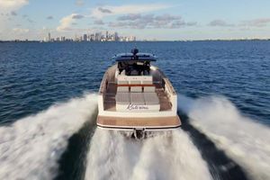 Pardo Yachts 43 2021 Pardo Yachts 43 cruising on open water with city skyline in background.