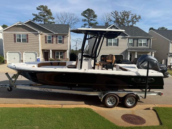 Robalo 226 Cayman 2024 Robalo 226 Cayman boat on trailer in suburban neighborhood.