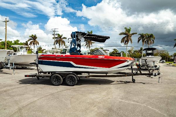 Nautique Super Air Nautique GS20 2025 Nautique Super Air Nautique GS20 boat on trailer, red and white design, palm trees background.
