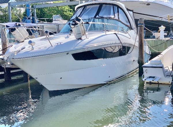 Sea Ray 330 Sundancer 2016 Sea Ray 330 Sundancer yacht docked in marina, side view.