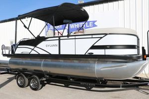 Sylvan Mirage X X1 CLZ DH 2025 Sylvan Mirage X X1 CLZ DH pontoon boat on trailer, parked outside dealership.