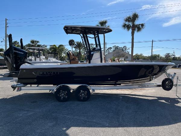 Robalo 246 Cayman 2025 Robalo 246 Cayman boat on trailer, parked outdoors under clear sky.