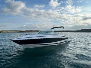 Regal 2550 Cuddy 2011 Regal 2550 Cuddy boat on calm water under a partly cloudy sky.