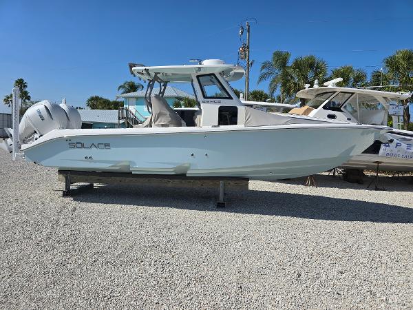 Solace 28 HCS 2025 Solace 28 HCS boat displayed on gravel lot with clear blue sky.