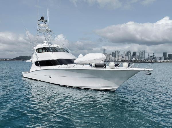 Hatteras 77 ENCLOSED BRIDGE 2008 Hatteras 77 Enclosed Bridge yacht on calm water with city skyline.