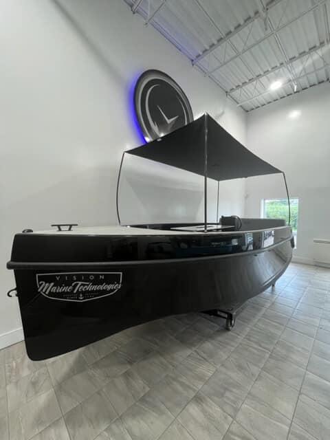 Vision Marine Technologies Volt 180 2023 Vision Marine Technologies Volt 180 boat displayed indoors with canopy.