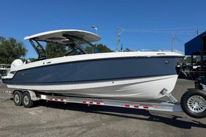 Monterey Elite 30 OB 2026 Monterey Elite 30 OB boat on trailer, sleek design, blue and white exterior.