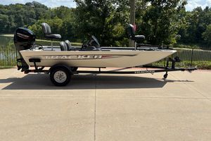Tracker Pro 170 2026 Tracker Pro 170 boat on trailer, parked near a scenic lake.