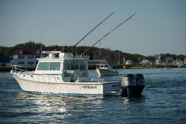 Steiger Craft 31 Fisherman 2024 Steiger Craft 31 Fisherman boat with dual outboard motors on the water.