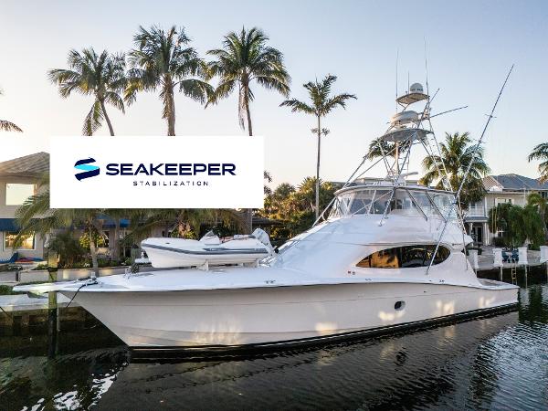 Hatteras 68 Convertible 2008 Hatteras 68 Convertible yacht with Seakeeper stabilization, docked near palm trees.