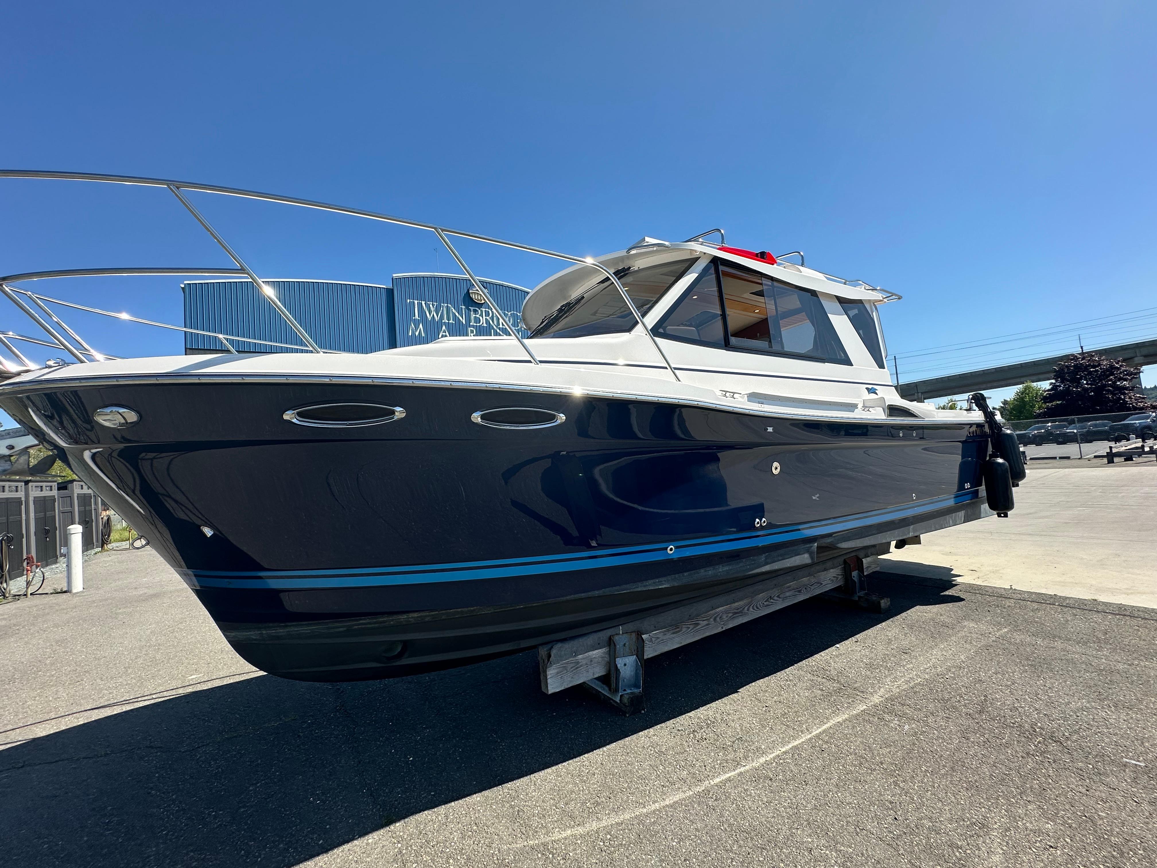 Cutwater C-28 2019 Cutwater C-28 boat on display at a marina under clear blue skies.