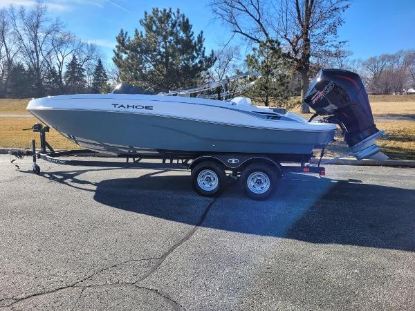 Tahoe T21 2024 Tahoe T21 boat on a trailer in a park setting.