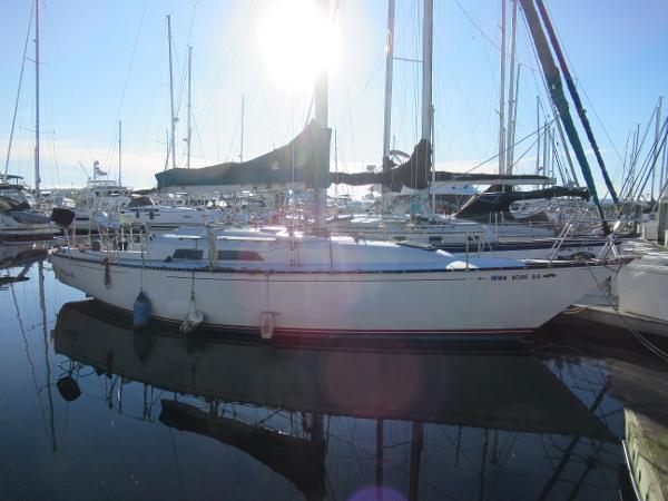 C&C 36 1981 C&C 36 sailboat docked in a marina, sun shining overhead.