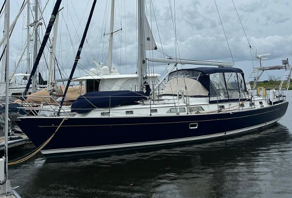 Passport 470 Sailboat docked in marina, 2004 Passport 470 model, with dark blue hull and white deck.