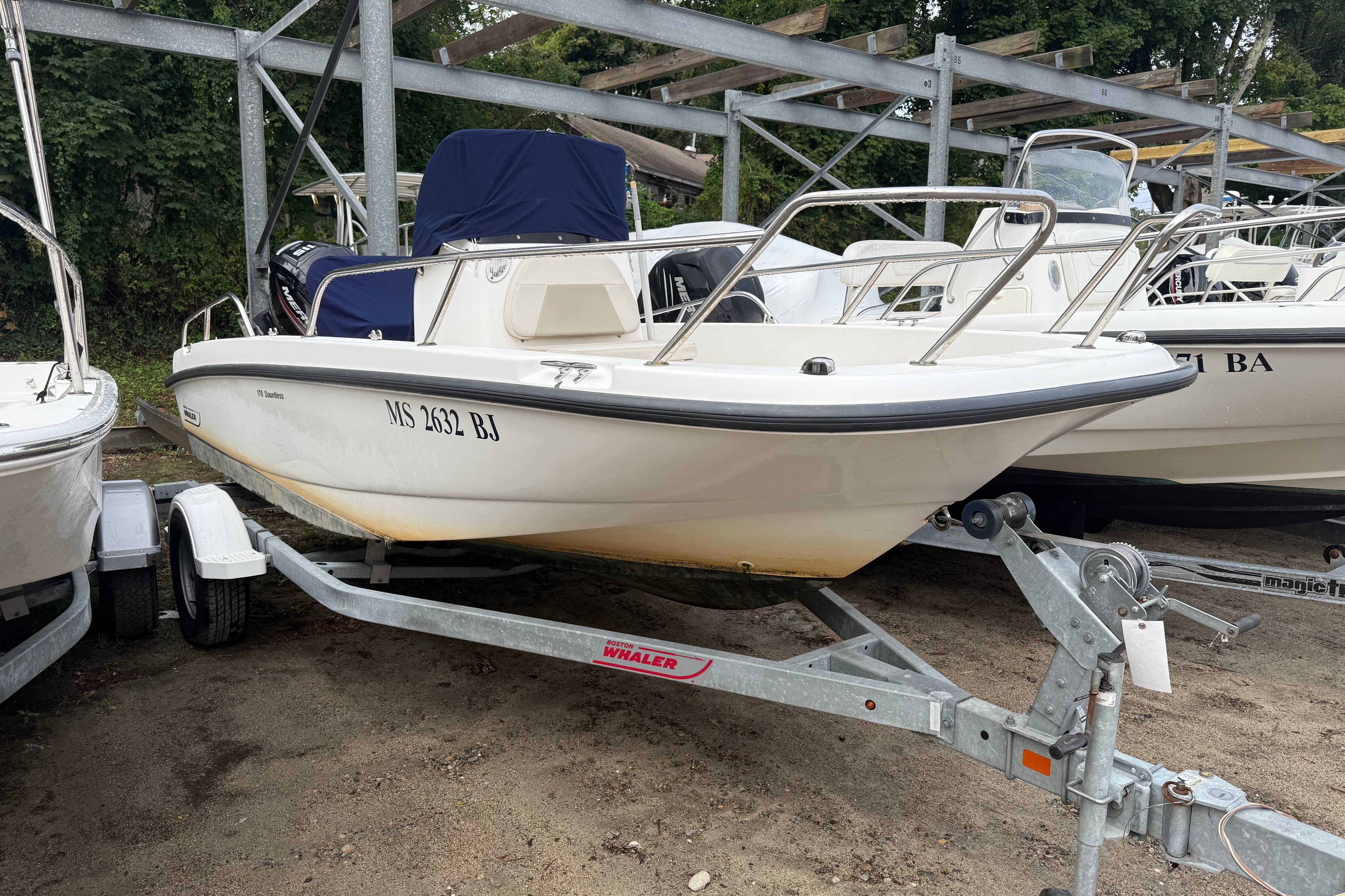 Boston Whaler 170 Dauntless 2017 Boston Whaler 170 Dauntless boat on trailer, parked outdoors.
