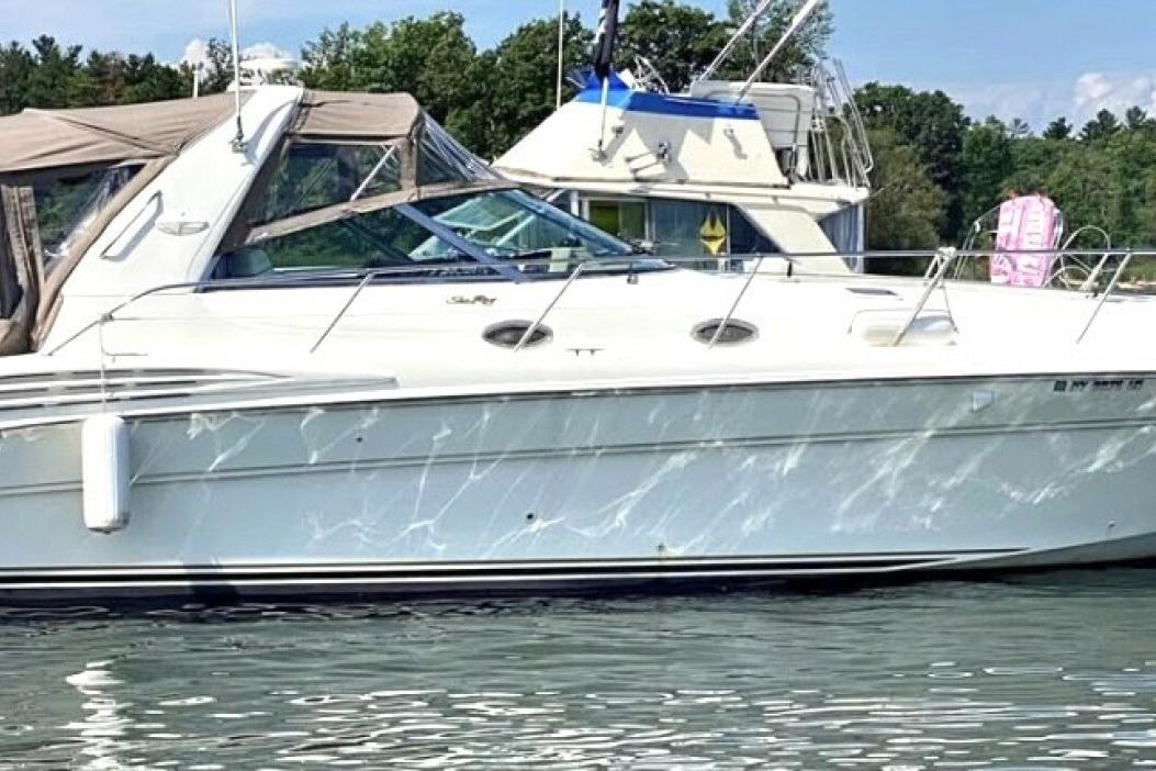 Sea Ray 400 Sundancer 1998 Sea Ray 400 Sundancer yacht on calm water, with trees in the background.