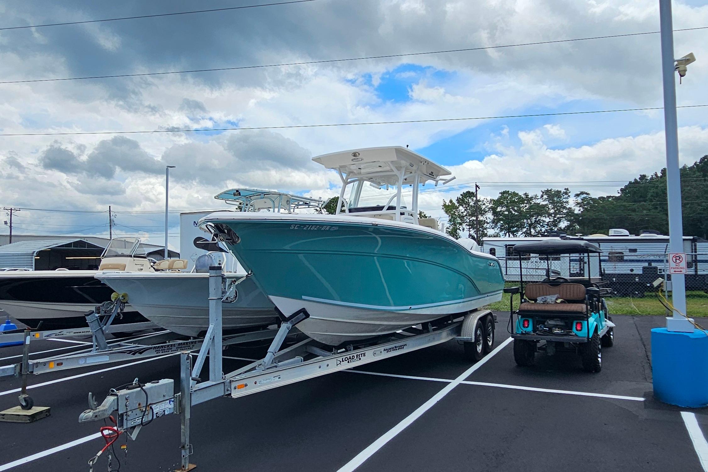 Sea Fox 266 Commander 2018 Sea Fox 266 Commander boat on trailer in parking lot under cloudy sky.