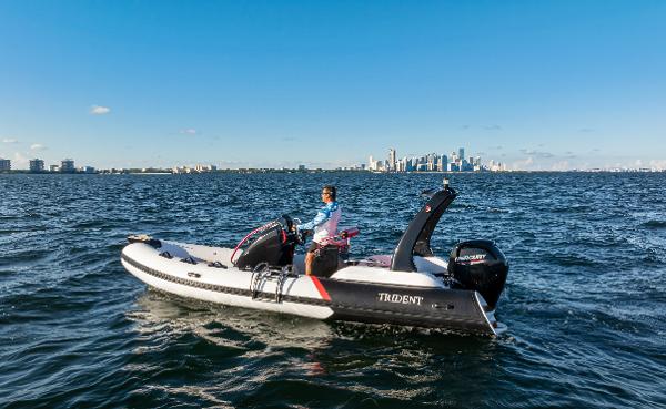 Trident 21 rib 2023 Trident 21 RIB boat on open water with city skyline in background.