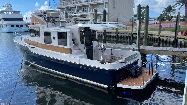 Ranger Tugs R-31 CB 2025 Ranger Tugs R-31 CB boat docked in marina, featuring sleek design and spacious deck.