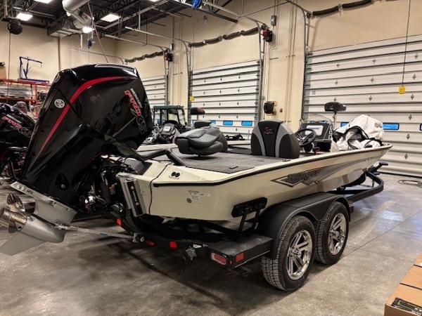Ranger ALPHA 208 2025 Ranger ALPHA 208 boat in a garage, featuring a powerful outboard motor.