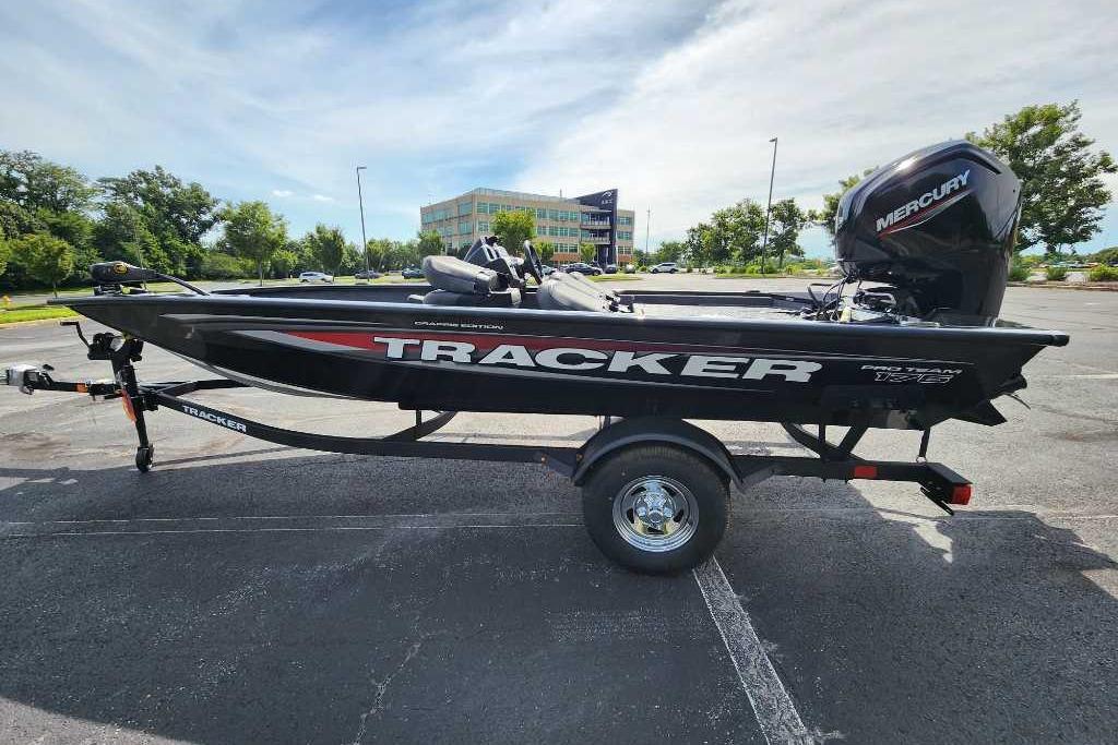 Tracker Pro Team 175 Crappie Edition 2026 Tracker Pro Team 175 Crappie Edition boat with Mercury engine in parking lot.