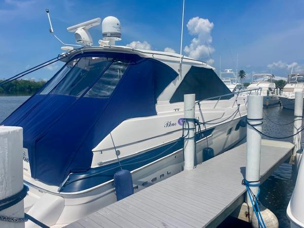 Regal 46 Sport Coupe 2011 Regal 46 Sport Coupe yacht docked at marina under clear blue sky.