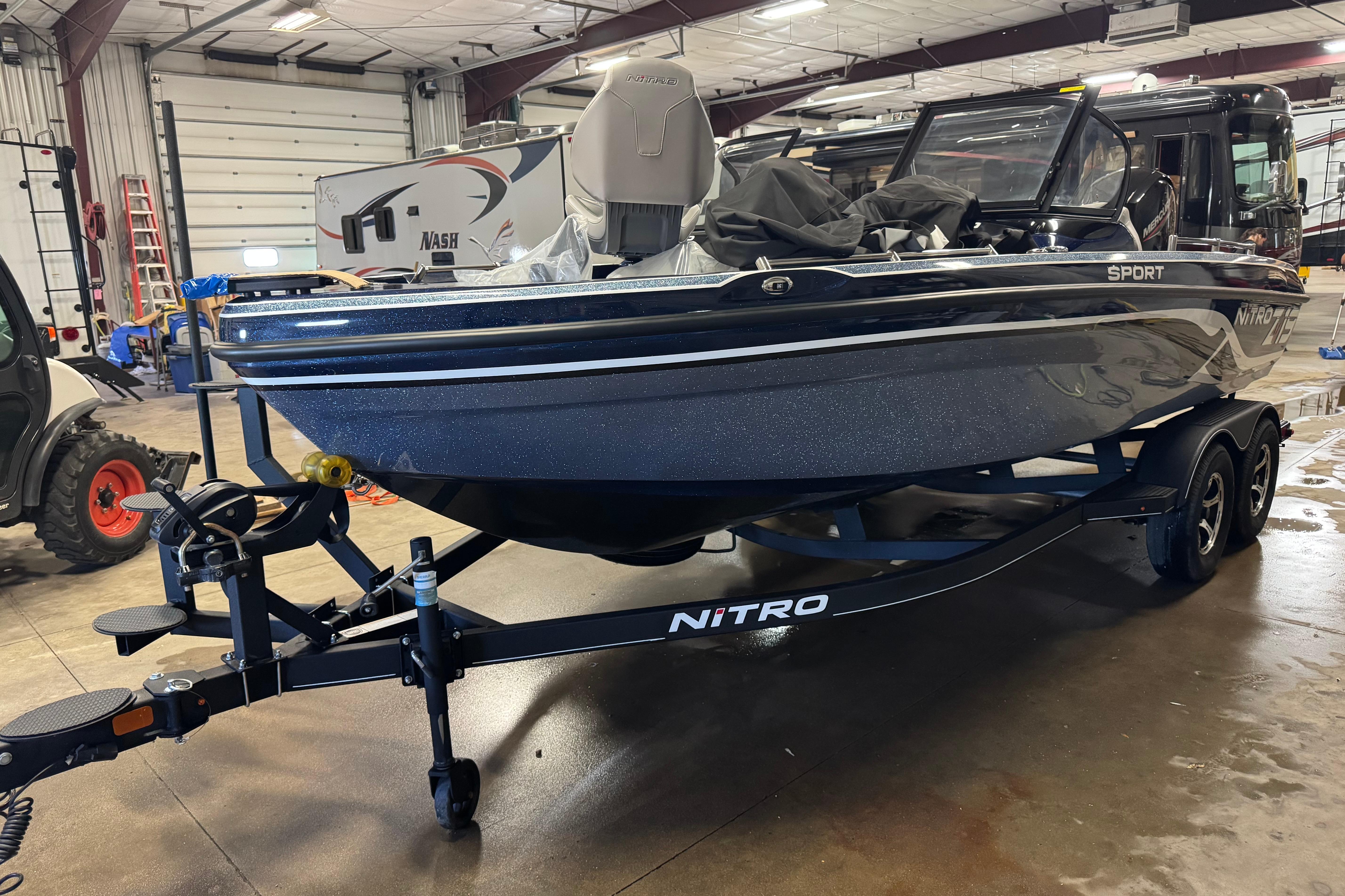 Nitro ZV19 Sport 2024 Nitro ZV19 Sport boat on trailer in indoor garage setting.