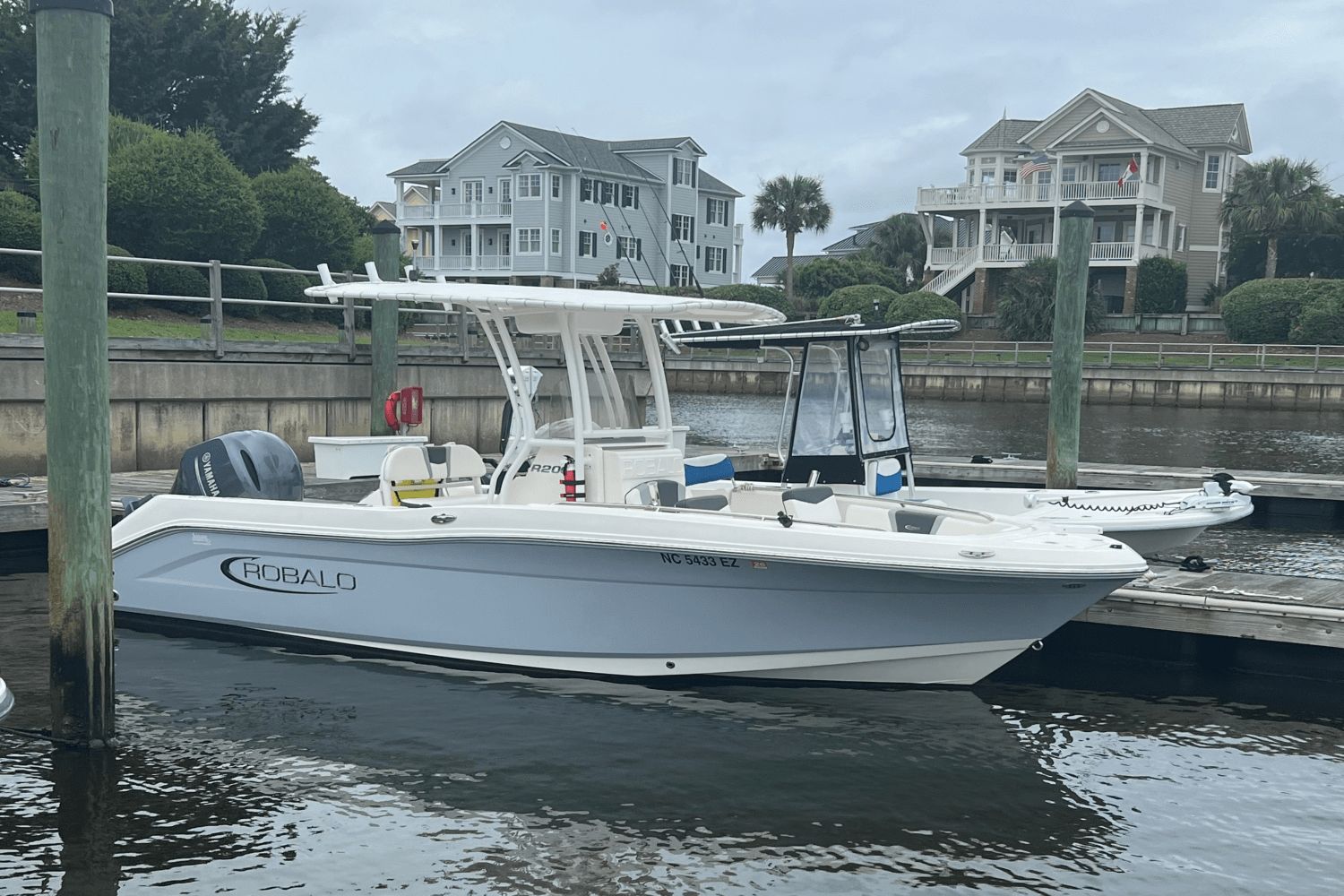Robalo R200 Center Console 2023 Robalo R 200 boat docked near waterfront homes.