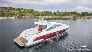 Azimut 62S 2008 Azimut 62S yacht cruising in scenic waters near rocky shoreline.