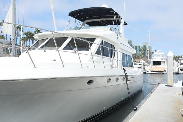 Navigator 53 Classic 2005 Navigator 53 Classic yacht docked at marina, featuring sleek white design and spacious deck.