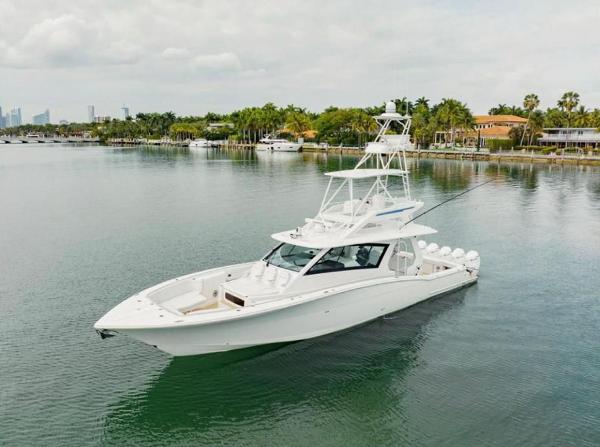 Scout 530 LXF 2021 Scout 530 LXF luxury yacht on calm water near a tropical shoreline.