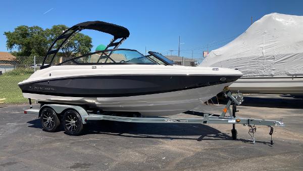 Regal 2000 ES 2024 Regal 2000 ES boat on a trailer in a parking lot.