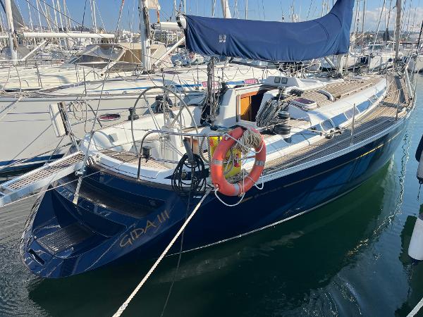 Grand Soleil 43 2005 Grand Soleil 43 sailboat docked in marina, featuring blue hull and lifebuoy.