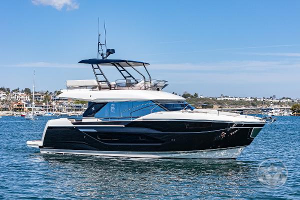 Prestige F4.9 2025 Prestige F4.9 yacht cruising on a sunny day, showcasing sleek design and luxury features.