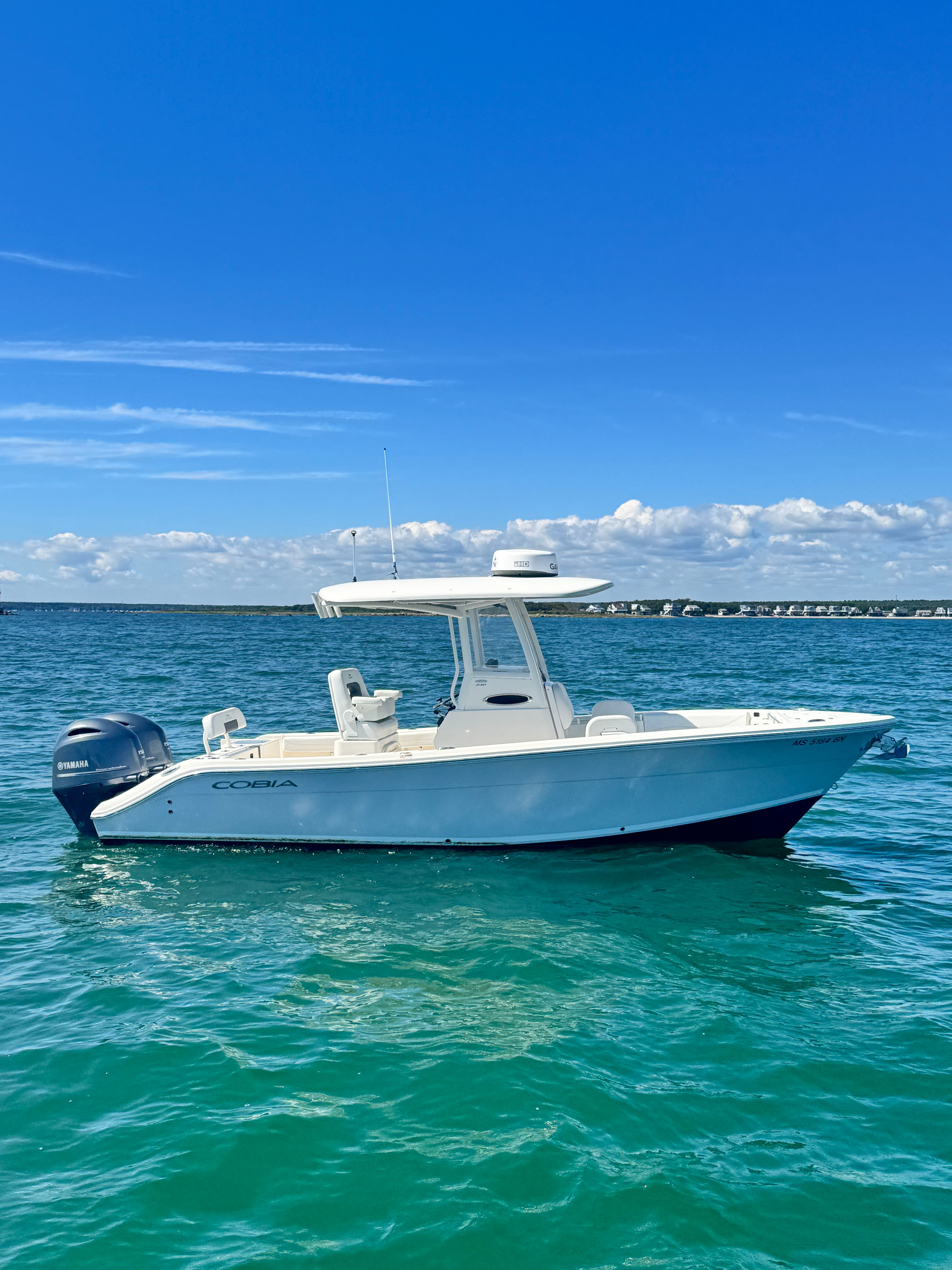 Cobia 240 Center Console 2020 Cobia 240 Center Console boat on clear blue water under a bright sky.