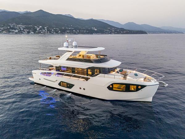 Absolute 70' Navetta Luxurious 2026 Absolute 70' Navetta yacht cruising on serene waters at sunset.