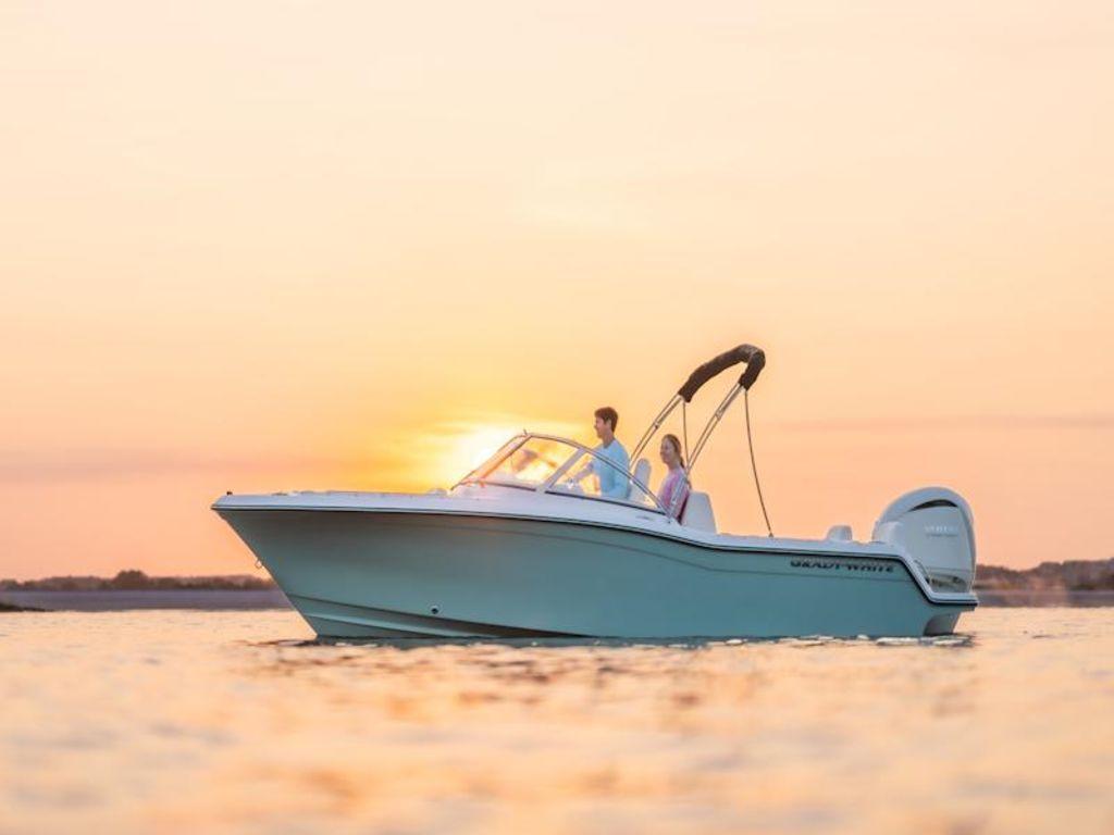 Grady-White Freedom 215 2026 Grady-White Freedom 215 boat cruising at sunset on calm waters.