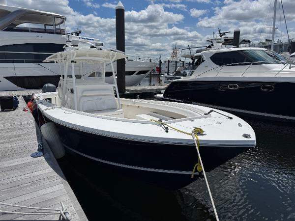 Regulator 34 Center Console 2014 Regulator 34 Center Console boat docked at marina under cloudy sky.