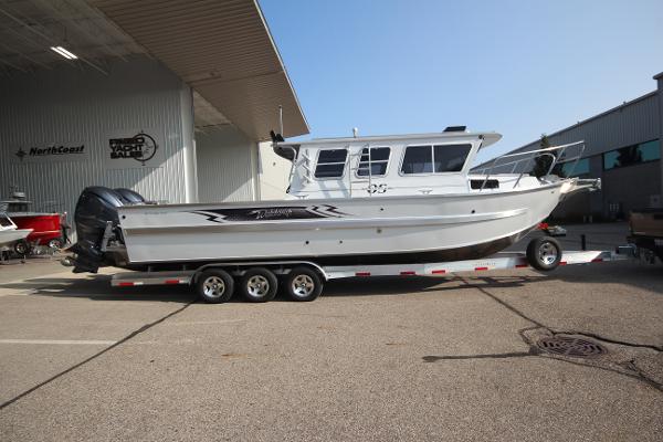 Weldcraft 300 Cuddy King OS 2025 Weldcraft 300 Cuddy King OS boat on trailer outside a warehouse.