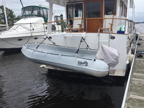 Whaly 370 Open A 2025 Whaly 370 boat secured to a docked yacht on calm waters.