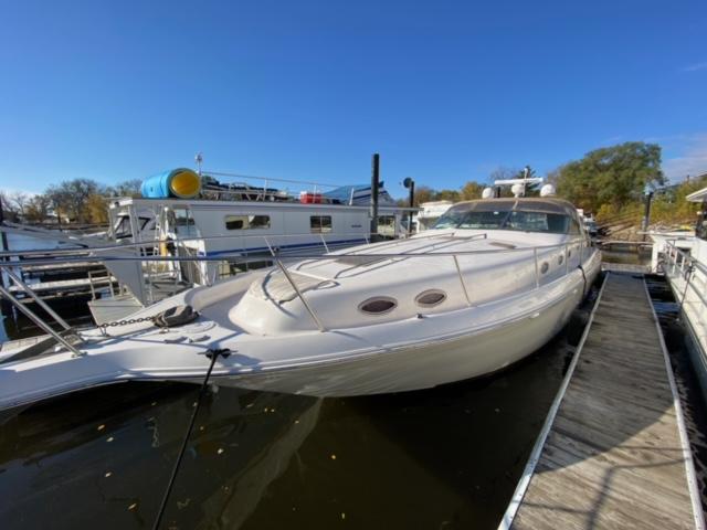Sea Ray 450 Sundancer 1997 Sea Ray 450 Sundancer yacht docked at marina under clear blue sky.