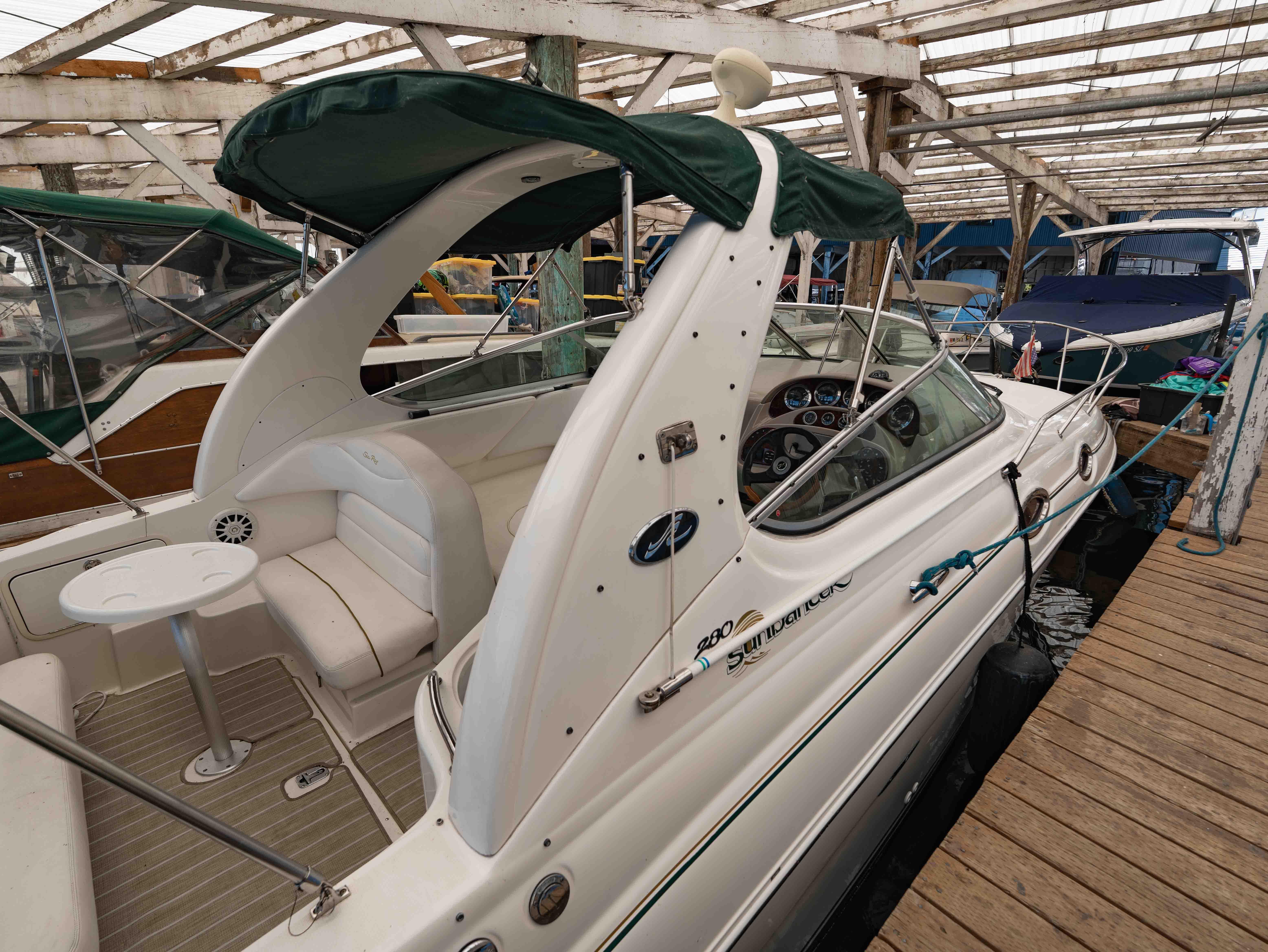 Sea Ray Sundancer 280 2001 Sea Ray Sundancer 280 docked in a covered marina, featuring a spacious cockpit.