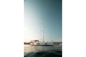 Dufour 470 2023 Dufour 470 sailboat on calm water under clear sky.