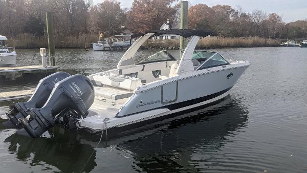 Chaparral 280 OSX 2020 Chaparral 280 OSX boat docked on calm water with Yamaha outboard engines.